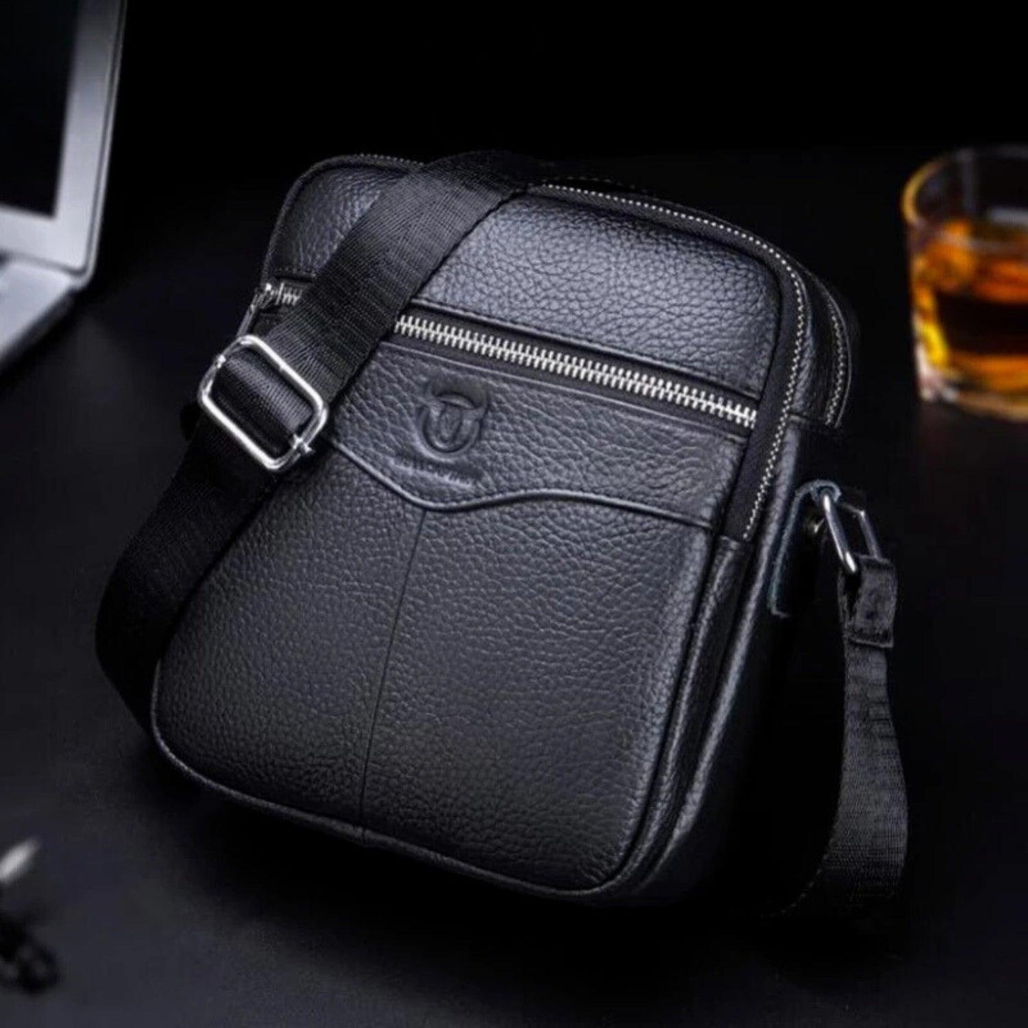 Bolso ejecutivo negro de cuero PU para hombre con correa ajustable y cierre metálico.