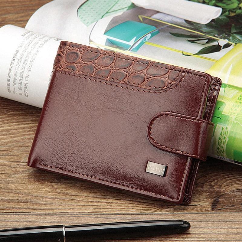 Cartera masculina compacta de cuero PU marrón con broche y diseño clásico sobre mesa.